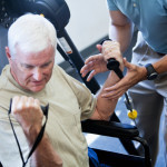man in wheelchair working out at the gym