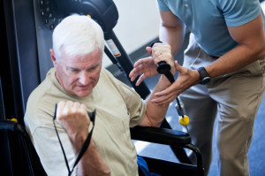 man in wheelchair working out at the gym